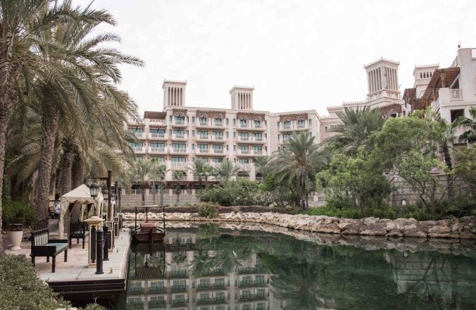 Canal and boat station in front of Villa 10 with view of main hotel