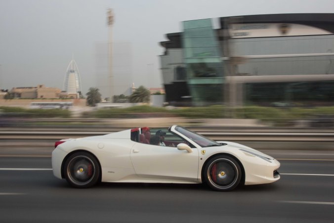 A ferrari with a distracted driver on our drive to the airport