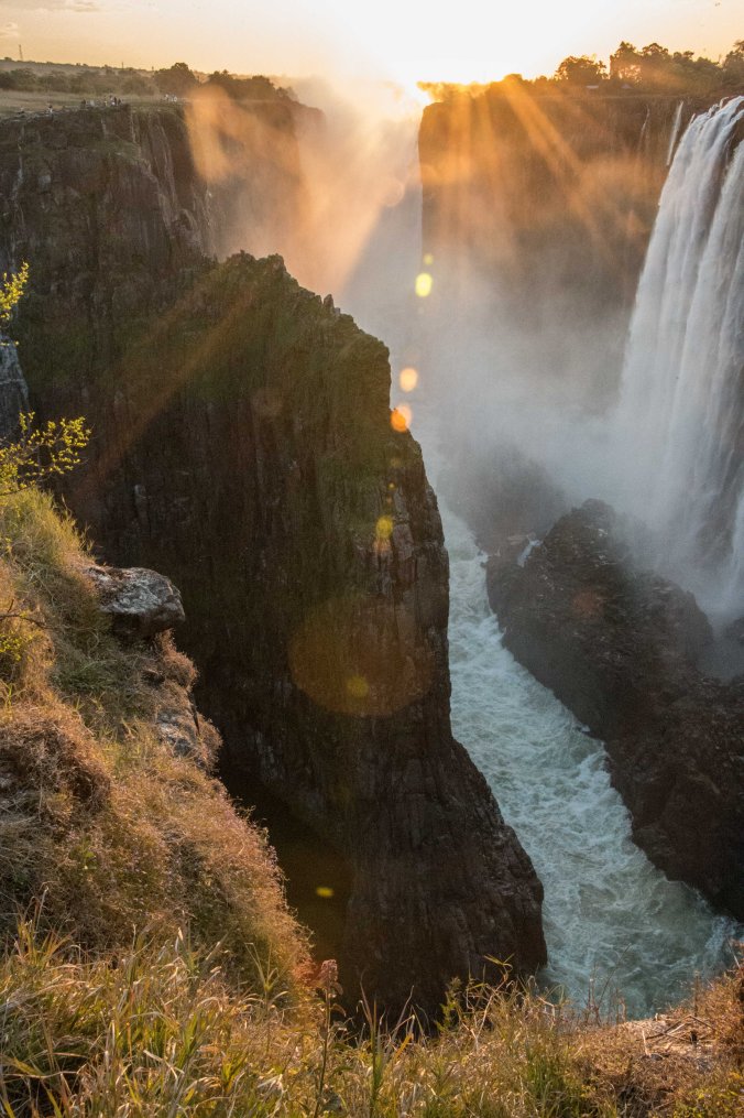 Sun setting over the falls looking to the Zimbabwe side (on the left)