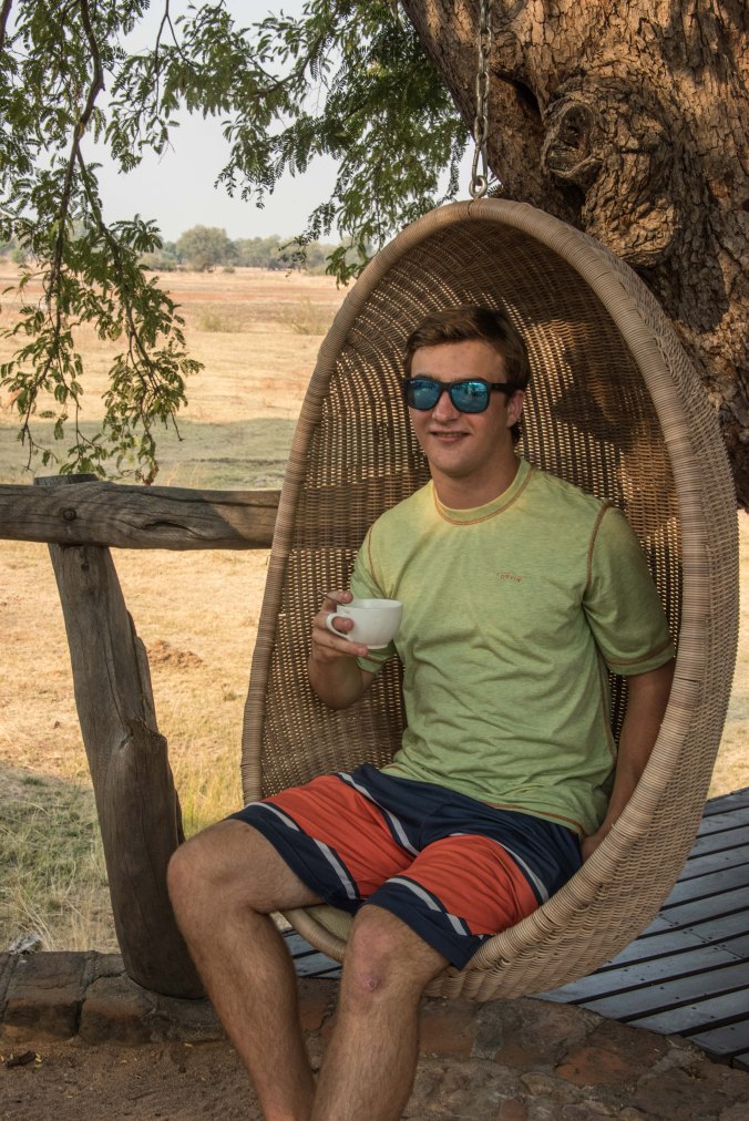 Casey drinking his morning coffee in the swing