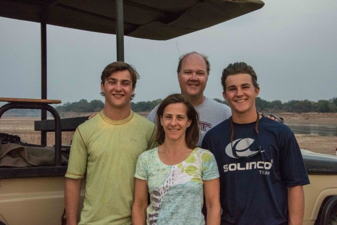 family shot by the river at sunset