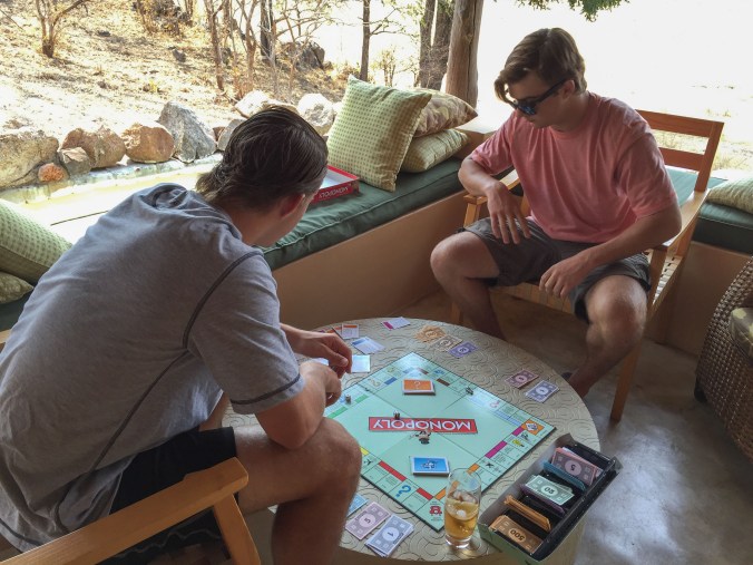 the boys playing monopoly at camp